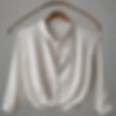 Elegant Cloth and Stone white blouse displayed on a vintage hanger